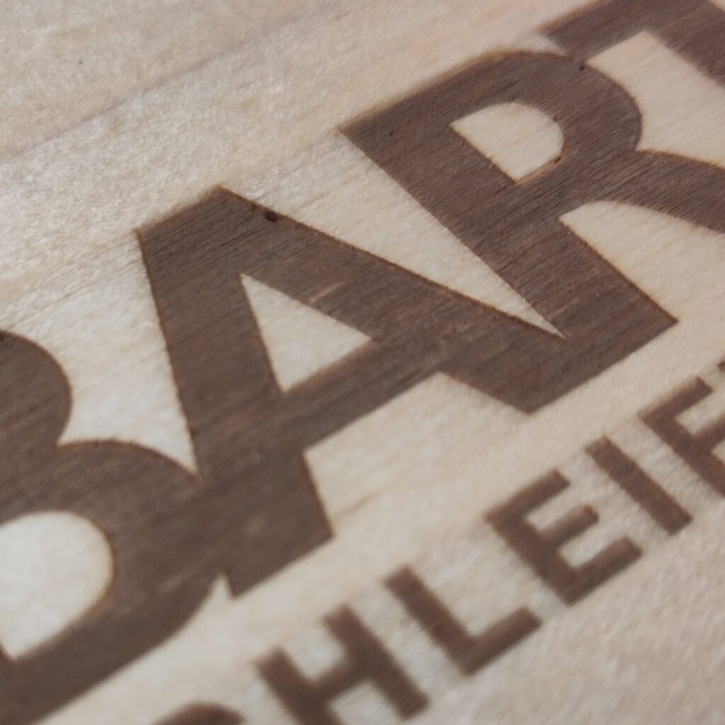 close-up on individually designed laser-engraving on a wooden folding box